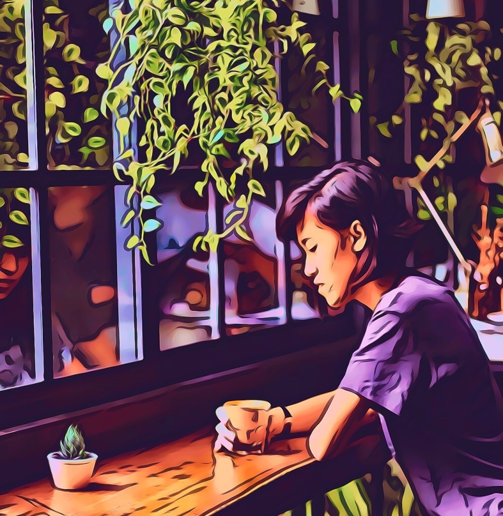 Woman in a purple shirt, thinking, in a coffee shop