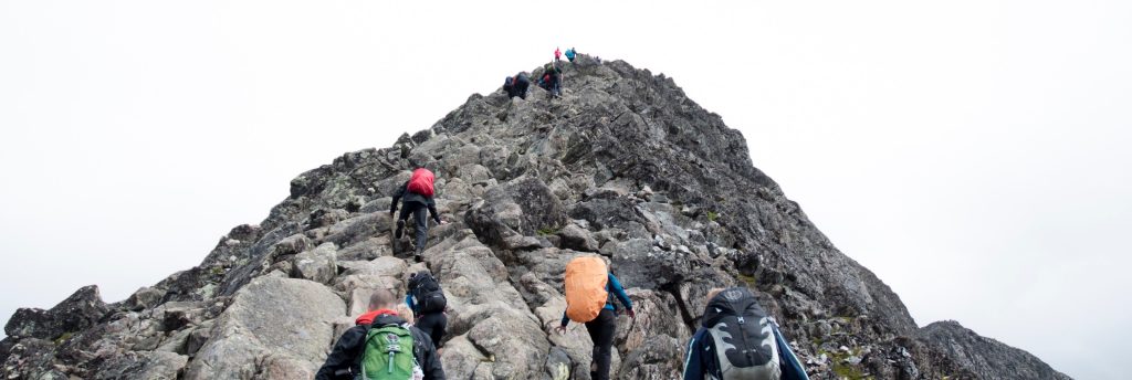 Hikers climbing up a steep mountain. - Photo by Mathias Jensen on Unsplash