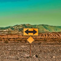 A sign in the desert pointing in two directions